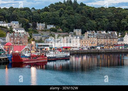 Oban waterfront at dusk with Caledonian MacBrayne ferry Loch Striven in Oban Bay, Scotland, viewed from the water. Stock Photo