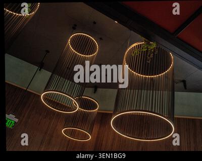 Dramatic ceiling lighting reflected onto a dark marble surface Stock Photo