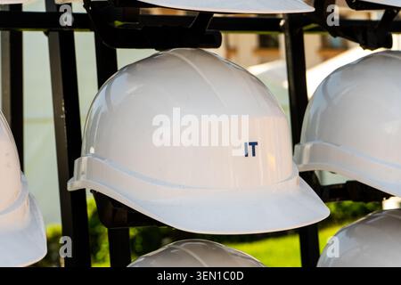 Close Up of White Construction Hard Hat Inscribed with IT Profession Text. Stock Photo