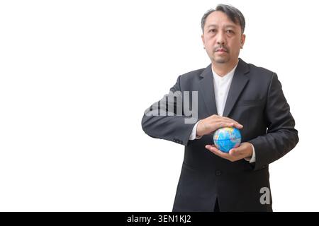 Professional businessman in a dark suit holding a colorful globe against a clean light gray background. The image represents global business, internat Stock Photo