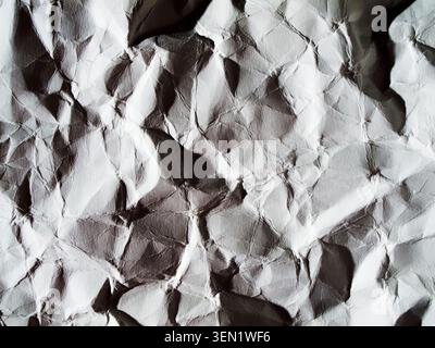 Format-filling view on crumpled and unfolded gray paper. Stock Photo