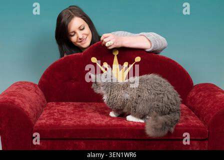 Young woman with Devon Rex tomcat Stock Photo