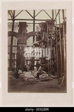 Workers labour around capitals placed on the ground at the construction site of the Opera Garnier in Paris in an 1866 photograph by Louis-Émile Durandelle. The scene records building activity, architectural elements and the progress of the major civic project. Stock Photo