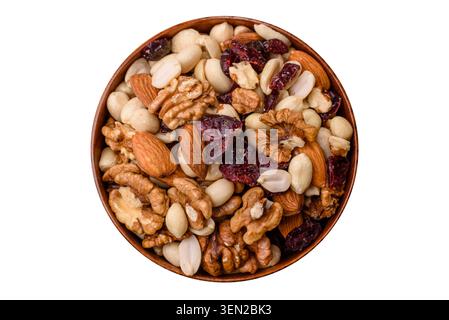 A mix of pistachios, hazelnuts, walnuts, peanuts, dried berries, and fruits as ingredients for a healthy meal. A mix of nuts as a food background for Stock Photo