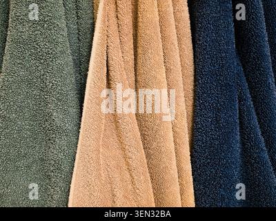 Colorful Cotton Bath Towels Hanging in Bathroom Close Up Texture Background Stock Photo