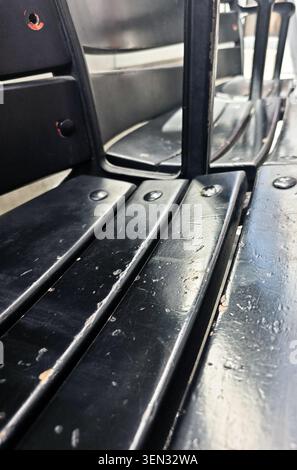 Close Up of Worn Black Bench Surface with Scratches and Abstract Texture Stock Photo