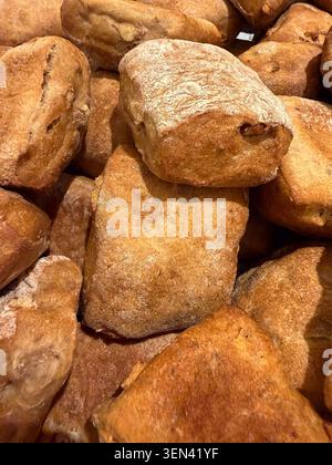 Rustic ciabatta rolls piled in a bakery display Stock Photo