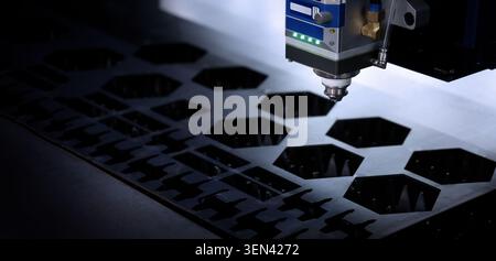 Laser cutting machine. High precision laser cutting robot processing sheet metal in factory. Ai automated CNC manufacturing technology creates intrica Stock Photo