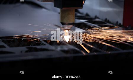 Laser cutting machine. High precision laser cutting robot processing sheet metal in factory. Ai automated CNC manufacturing technology creates intrica Stock Photo