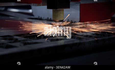 Laser cutting machine. High precision laser cutting robot processing sheet metal in factory. Ai automated CNC manufacturing technology creates intrica Stock Photo