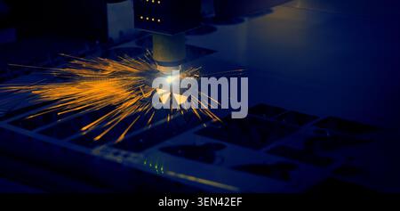 Laser cutting machine. High precision laser cutting robot processing sheet metal in factory. Ai automated CNC manufacturing technology creates intrica Stock Photo