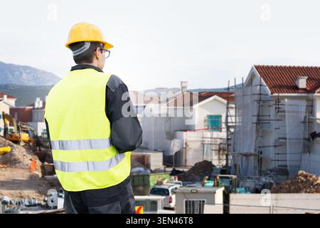 Сivil engineer with tablet computer looking at construction site Stock Photo