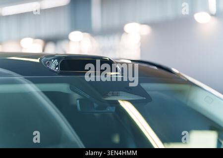 Autonomous driving technology with LiDAR sensor on car roof and ADAS cameras behind windshield Stock Photo
