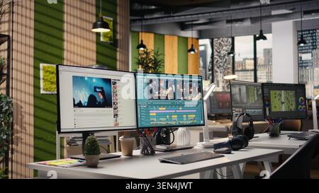 Studio with no people shows PC with advanced video editing software, interface displays recorded footage with sync tools and toolbar panels for adjustments. Creative post production process. Stock Photo