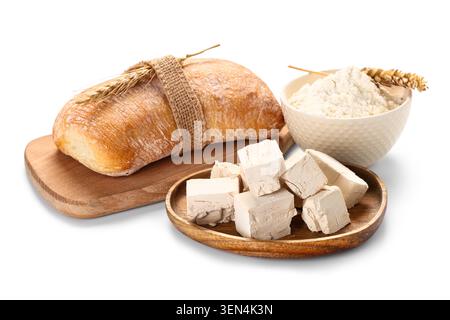 Freshly baked ciabatta bread with wheat flour and yeast cubes on white background, baking ingredients Stock Photo