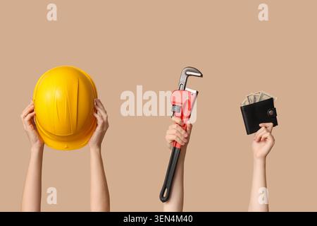 Construction worker career choice with hard hat, pipe wrench, and wallet full of money on neutral background Stock Photo