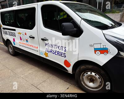 Manchester, UK - May 07, 2026: White nursery minivan with playful child illustrations and Paintpots Nurseries branding in Manchester UK. Stock Photo