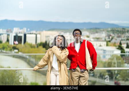 Relaxed african american married travelers on sightseeing spree in new city enjoying view. Stock Photo
