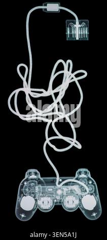 X-ray of a games console controller, showing joysticks, buttons and wire connection. Stock Photo