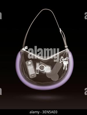 Coloured X-ray of a handbag and its contents. Stock Photo