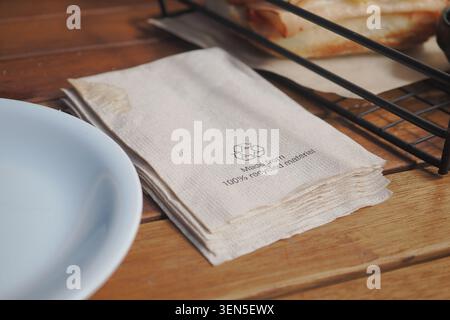 Recycled napkins placed on a wooden table in a cafe Stock Photo