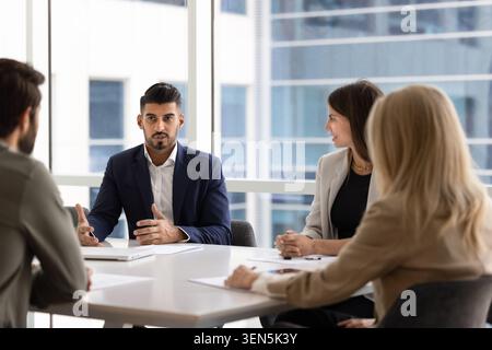 Serious Indian businessman presenting ideas to team Stock Photo