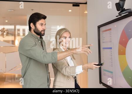 Colleagues brainstorming, exchanging ideas, engaged in teamwork Stock Photo