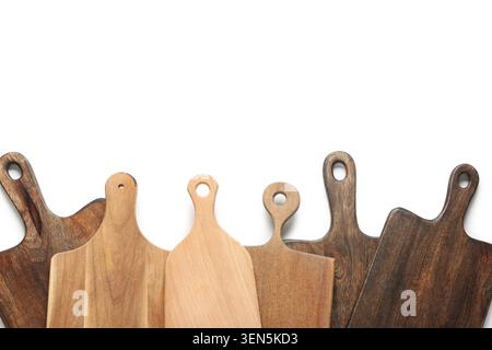 Assortment of wooden cutting boards with handles, kitchen utensils for food preparation and serving, isolated on white background Stock Photo