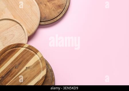 Assorted round wooden cutting boards and serving platters on pink background, kitchen utensils and food preparation, these kitchen utensils provide a Stock Photo