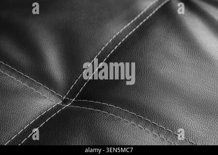Black leather upholstery with white stitching detail, luxury furniture material texture, modern interior design element Stock Photo
