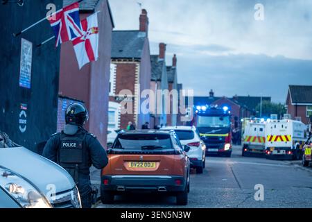 Belfast, UK. 09th June, 2026. Riot Police arrive at the scene of a fire lit by protestors in Belfast. Belfast erupted into flames as locals took to the streets to protest against the stabbing of a North Belfast man by a Sudanese national refugee. Road blockades were set up all over Belfast bringing much of the city to a standstill. The protestors are demanding a stop to immigration into Northern Ireland. Credit: SOPA Images Limited/Alamy Live News Stock Photo
