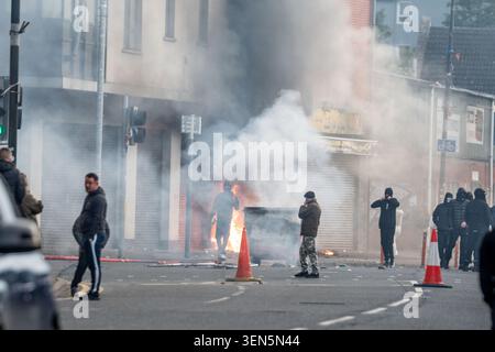 Belfast, UK. 09th June, 2026. Belfast youths burn down a grocery store owned by an immigrant during the protest. Belfast erupted into flames as locals took to the streets to protest against the stabbing of a North Belfast man by a Sudanese national refugee. Road blockades were set up all over Belfast bringing much of the city to a standstill. The protestors are demanding a stop to immigration into Northern Ireland. Credit: SOPA Images Limited/Alamy Live News Stock Photo
