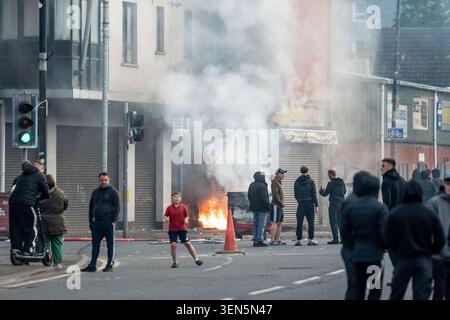 Belfast, UK. 09th June, 2026. Belfast youths burn down a grocery store owned by an immigrant. Belfast erupted into flames as locals took to the streets to protest against the stabbing of a North Belfast man by a Sudanese national refugee. Road blockades were set up all over Belfast bringing much of the city to a standstill. The protestors are demanding a stop to immigration into Northern Ireland. Credit: SOPA Images Limited/Alamy Live News Stock Photo