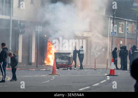 Belfast, UK. 09th June, 2026. Belfast youths burn down a grocery store owned by an immigrant. Belfast erupted into flames as locals took to the streets to protest against the stabbing of a North Belfast man by a Sudanese national refugee. Road blockades were set up all over Belfast bringing much of the city to a standstill. The protestors are demanding a stop to immigration into Northern Ireland. Credit: SOPA Images Limited/Alamy Live News Stock Photo