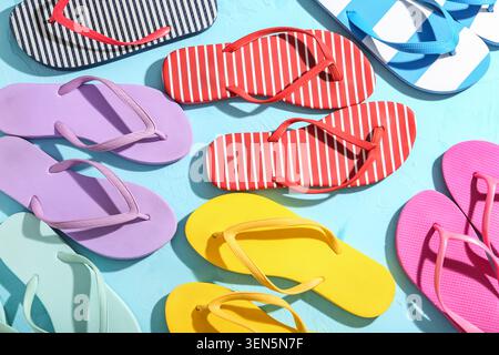 Colorful summer flip flops on blue background, vacation and beach lifestyle, holiday travel and leisure footwear Stock Photo