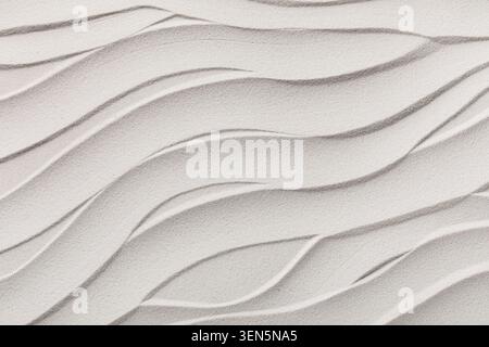 White sand texture with wavy lines and smooth dunes, natural beach background for serene design and relaxation concepts Stock Photo
