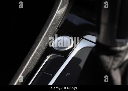 Modern car interior start stop engine button and gear shift lever, automotive technology and driving experience, the sleek design and metallic accents Stock Photo