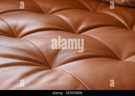 Brown tufted leather upholstery texture, luxurious furniture material, elegant interior design detail, high-quality craftsmanship Stock Photo