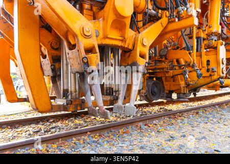 Rail maintenance at work, featuring specialized utility machine mechanism vehicle on the tracks. Stock Photo