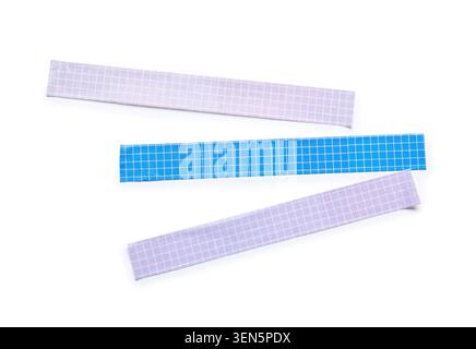 Three colorful grid patterned adhesive tapes for crafting and office supplies, isolated on a clean white background, three pieces of adhesive tape wit Stock Photo