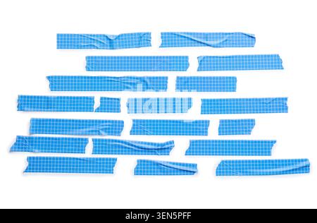 Blue grid masking tape pieces with torn edges, adhesive strips for repair and decoration, isolated on white background Stock Photo