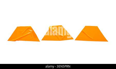 Three orange adhesive tape pieces with wrinkles and folds, abstract design element for graphic projects Stock Photo