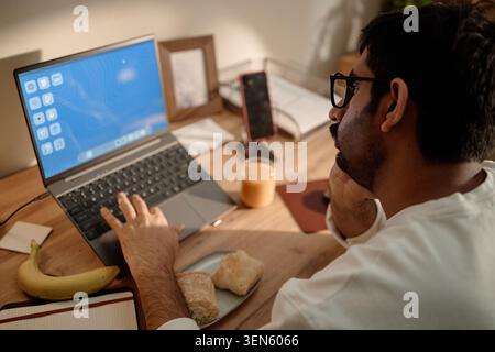 Adult Man Using Laptop Working from Home Stock Photo