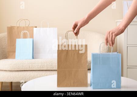 Hands arranging assorted shopping bags on table, retail therapy and consumerism concept, online shopping and delivery Stock Photo