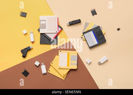 Retro floppy disks, USB flash drives, and micro SD cards on a modern geometric background Stock Photo
