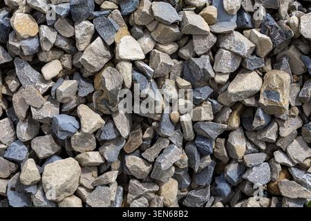 Pile Of Crushed Stones And Gravel. Close-up texture of mixed crushed stones and gravel, useful for construction, landscaping, background, and material Stock Photo
