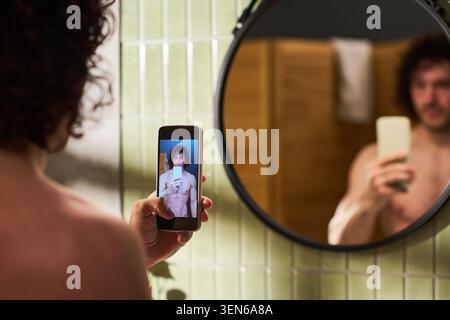 Adult Man Taking Smartphone Self Portrait during Home Grooming Stock Photo