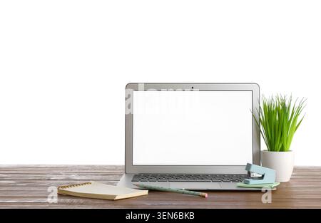 Modern laptop with blank screen on wooden desk, office supplies, and green plant, isolated on white background Stock Photo