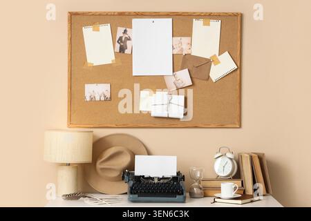 Vintage typewriter and cork board with blank papers on a creative workspace desk Stock Photo
