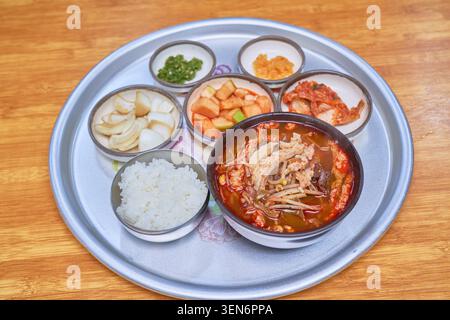 Traditional hot sugure beef soup served alongside white rice and kimchi side dishes on a metal tray as documented in tnrnrpf 1.jpg and tnrnrpf.jpg tod Stock Photo
